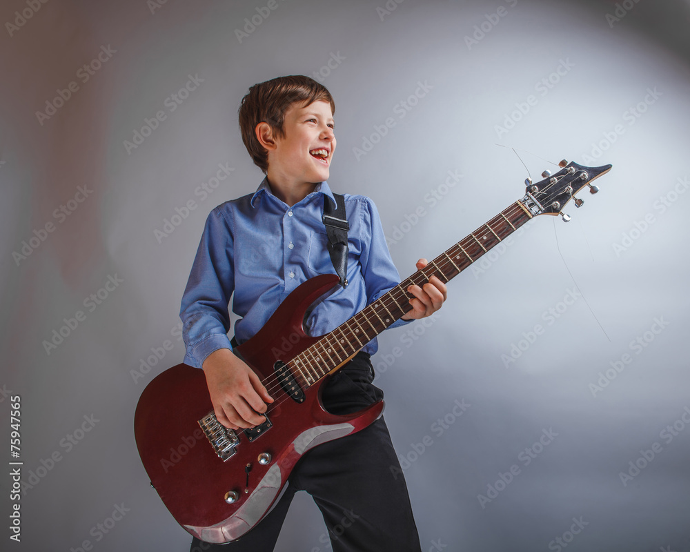Fototapeta premium teenager boy 10 years of European appearance smiles plays gui