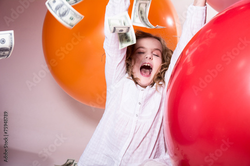 Happy teenage girl with an open mouth and falling on top of doll
