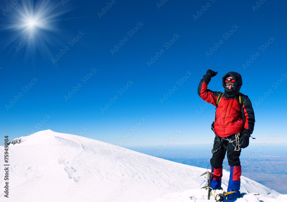Lone male mountain climber on summit