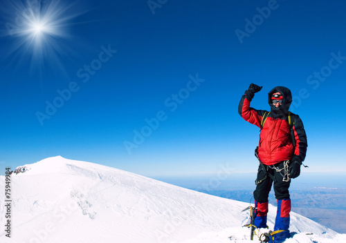 Lone male mountain climber on summit