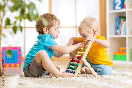 kids boys playing with abacus