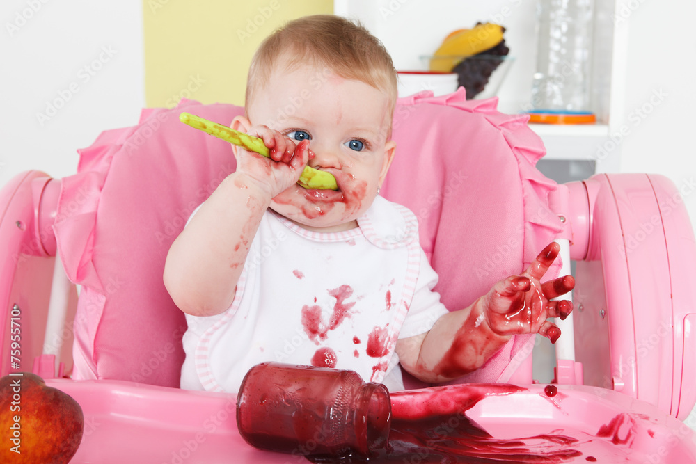 Naughty baby eating alone in the high chair Naughty baby eating alone in the high chair