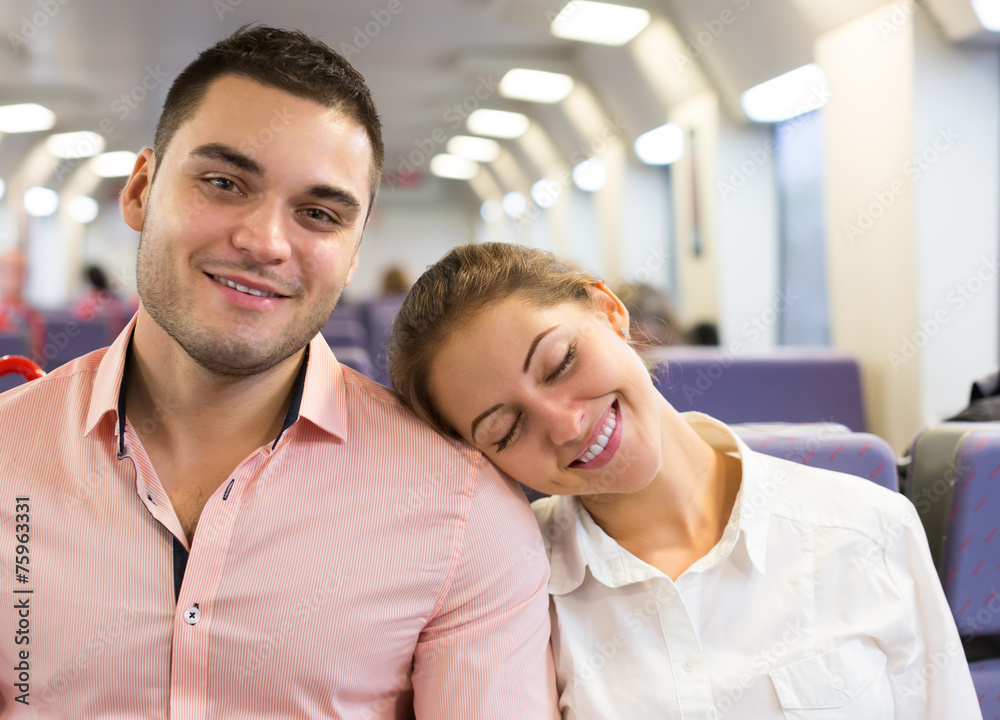 Young couple sitting in modern train
