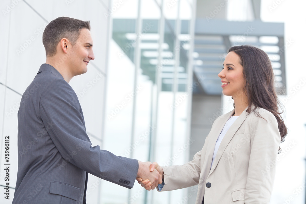 Fototapeta premium Young businesspeople shaking hands