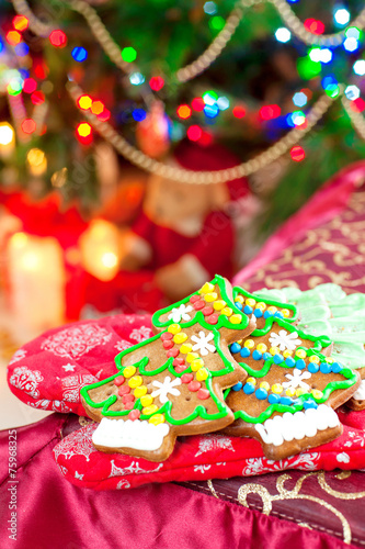 Homemade christmas tree shape gingerbread cookies on illuminated