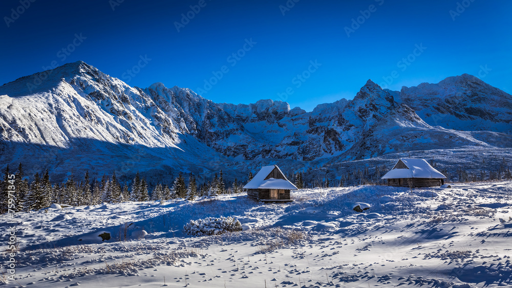 Winter cottages in the high mountains