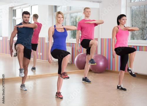 Fit people training in fitness club