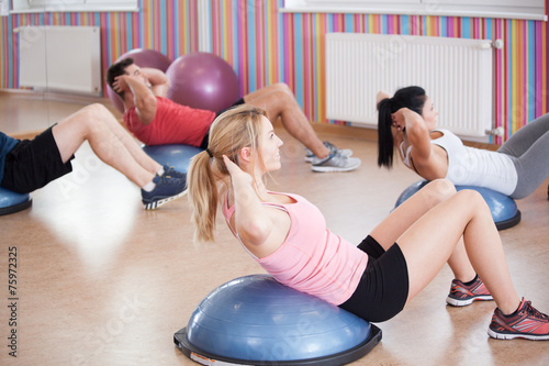 Doing crunches on the bosu photo