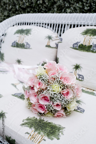 Bouquet of pink roses on sofa