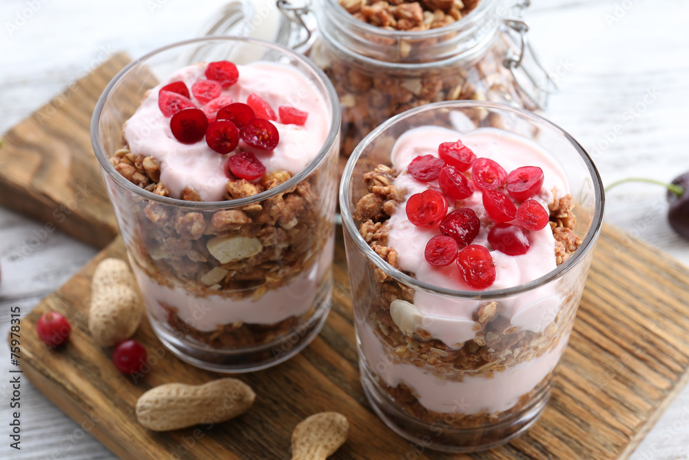 Healthy layered dessert with muesli and berries on table Healthy layered dessert with muesli and berries on table