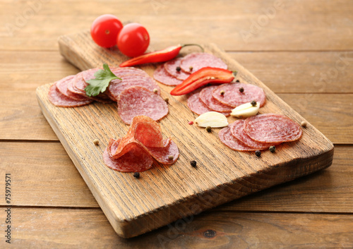 Slices of salami with spices and vegetables