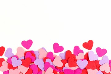 Valentines Day border of colorful paper hearts over white