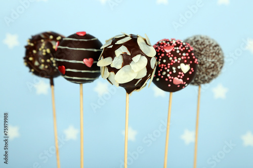 Tasty cake pops on blue background