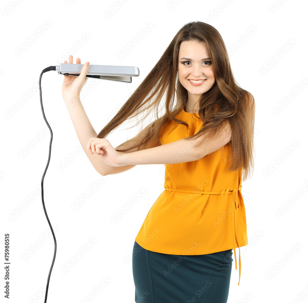 Beautiful young woman with long hair using hair straighteners Beautiful young woman with long hair using hair straighteners
