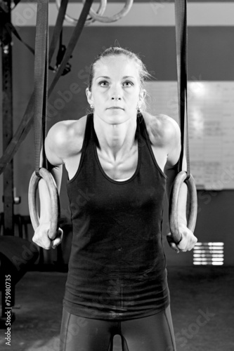 dip ring young woman dipping exercise - crossfit workout.