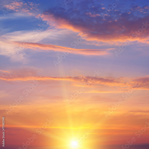 the sun rays illuminate the sky above the horizon © alinamd