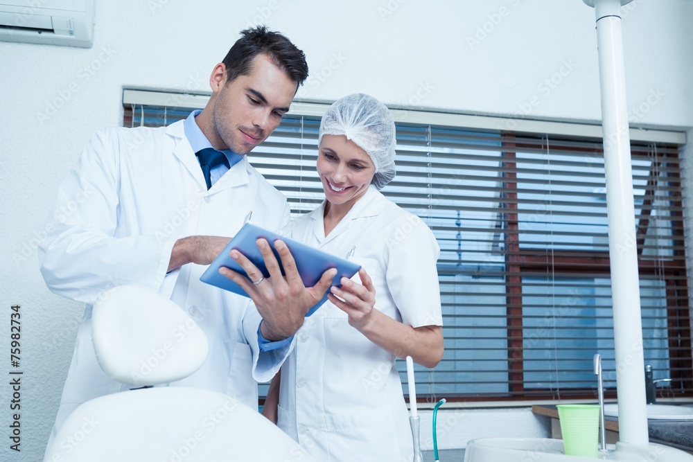 Fototapeta premium Dentists using digital tablet