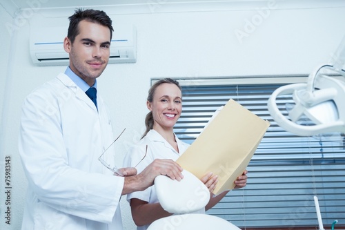 Portrait of dentists with reports