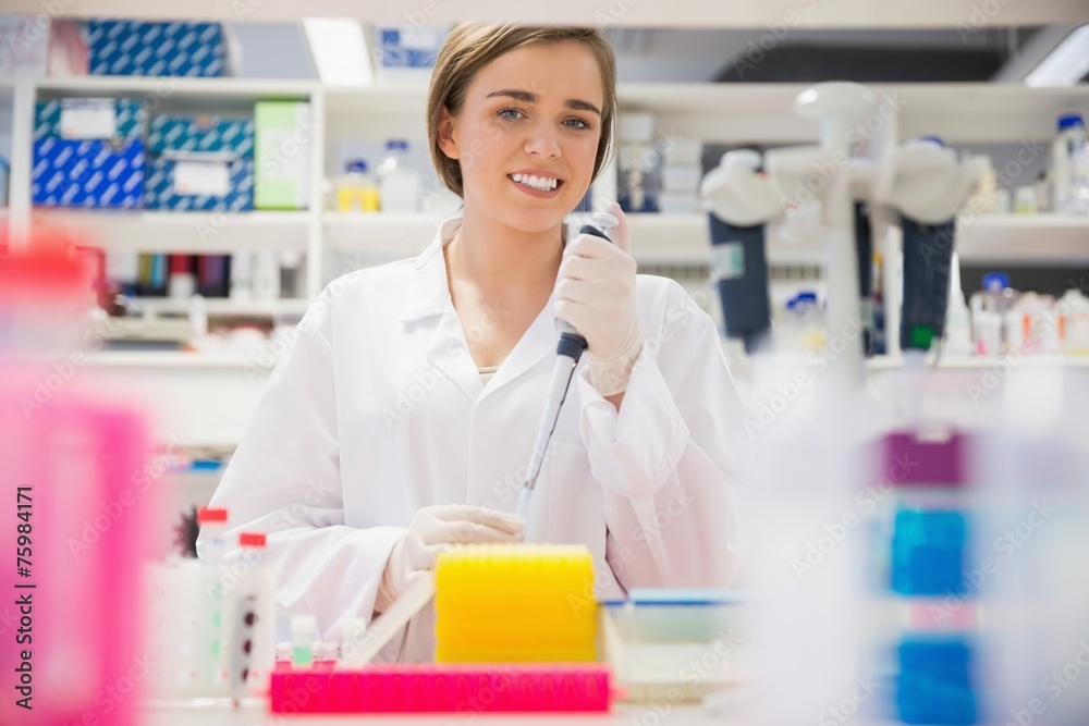 Pretty science student using pipette Pretty science student using pipette