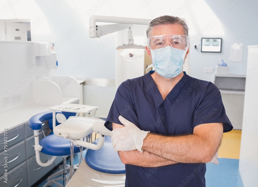 Portrait of a dentist with arms crossed and surgical mask Portrait of a dentist with arms crossed and surgical mask