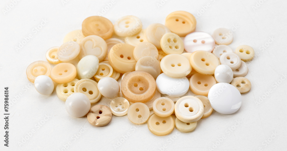 Obraz premium Beige sewing buttons isolated on white