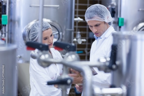 Tableau sur toile Biologist team talking and wearing hairnet