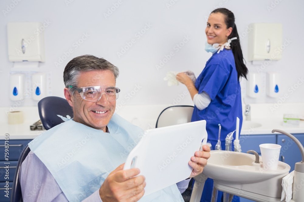 Smiling patient holding a mirror Smiling patient holding a mirror