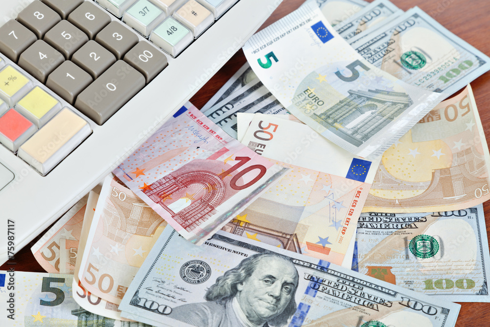 Cash register and different paper currencies foreground Cash register and different paper currencies foreground