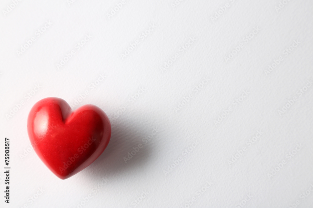 Beautiful decorative heart on white paper background, close-up Beautiful decorative heart on white paper background, close-up