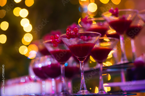 Line of different colored cocktails with smoke on a party