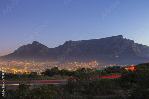 Table Mountain at dusk with passing cars and city lights