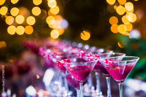 Line of different colored cocktails with smoke on a party