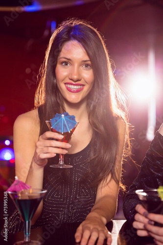 Pretty brunette drinking a cocktail