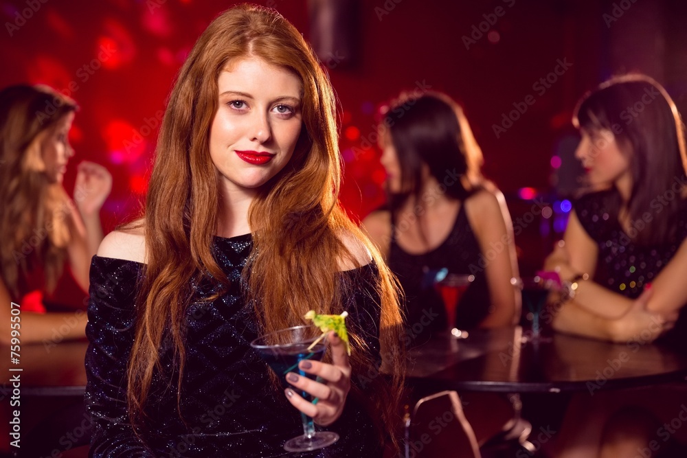 Pretty redhead drinking a cocktail