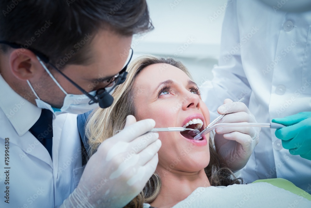 Woman having her teeth examined Woman having her teeth examined