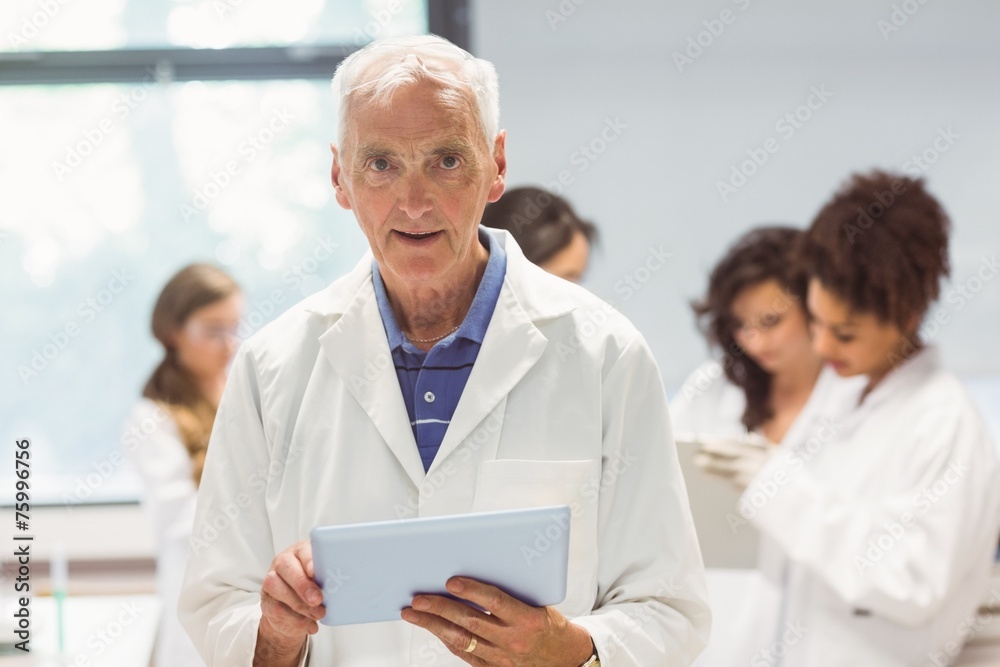 Fototapeta premium Science lecturer holding tablet pc in lab