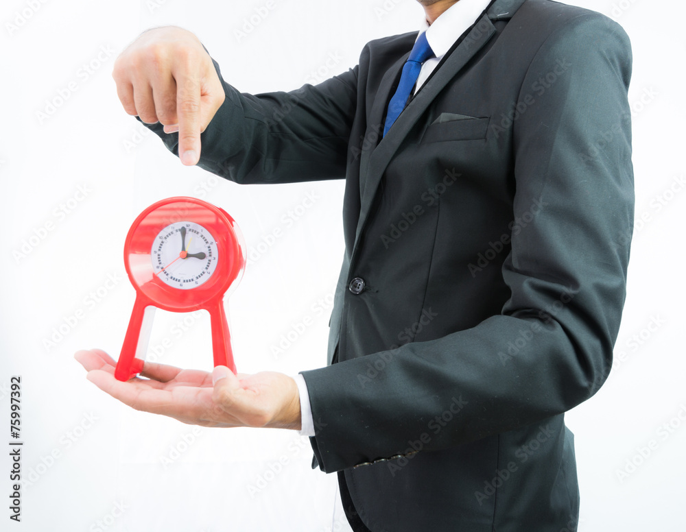 Red clock holding in businessman hands isolated Red clock holding in businessman hands isolated