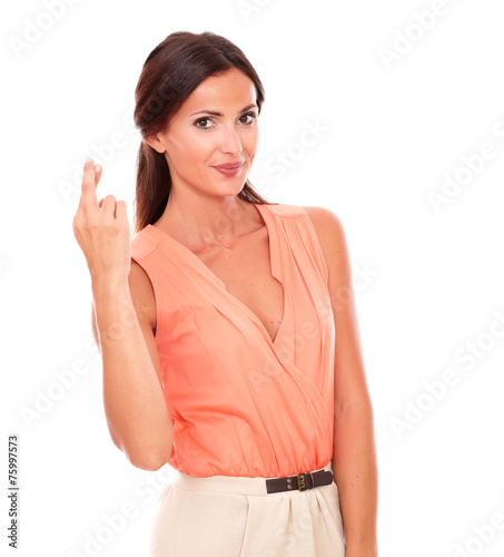 Charming female crossing fingers as luck sign