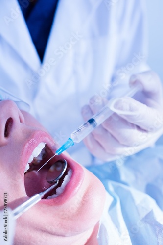 Dentist about to give injection to patient