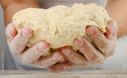 Hands holding a dough