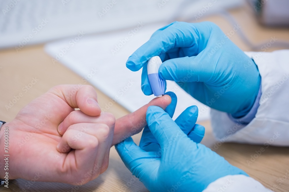 Doctor testing his patients blood Doctor testing his patients blood