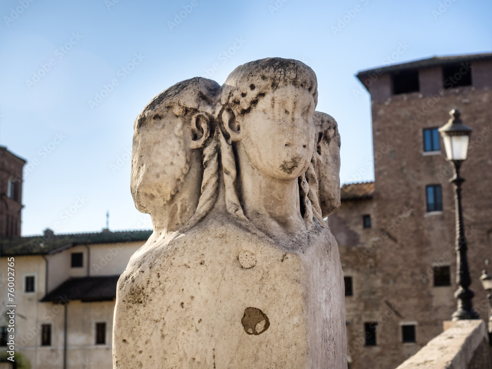 Four heads marble pillars the Ponte Fabricio Bridge in Rome