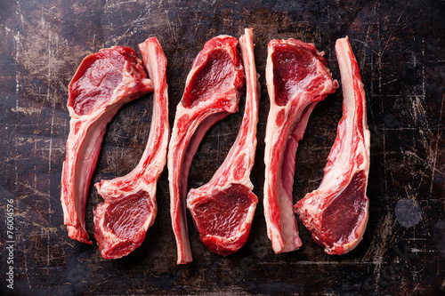 Raw fresh lamb ribs on dark background photo