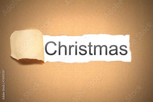 brown paper torn to reveal christmas