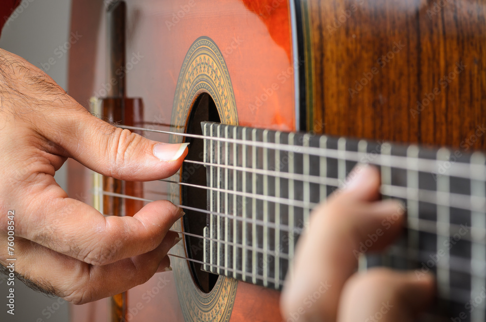 Fototapeta premium Closeup of a Man hands playing classical gutar