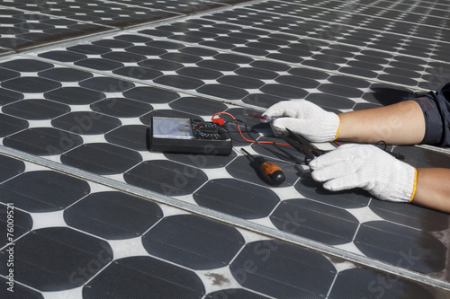 worker repair energy photovoltaic solar panels photo