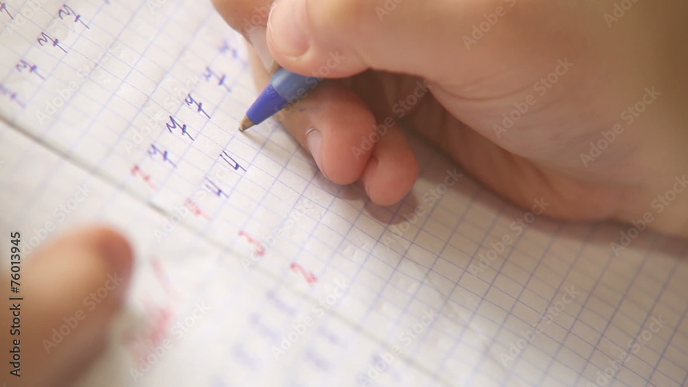 Little pupil write digits in square grid notebook Little pupil write digits in square grid notebook