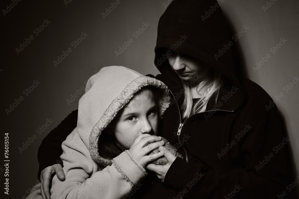 Homeless mother with her daughter. Poor family.