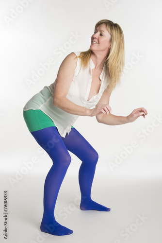 Woman in blue tights dancing a twerker dance