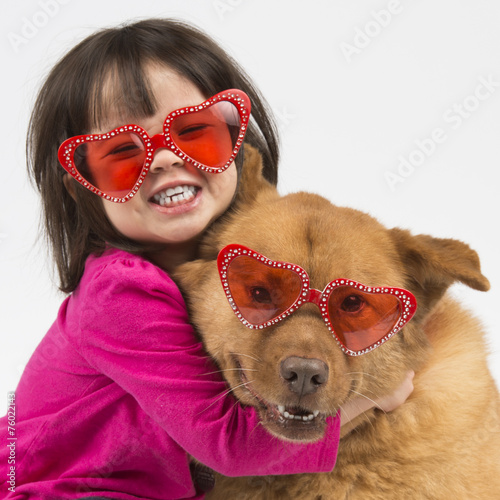 Dog hugged by child
